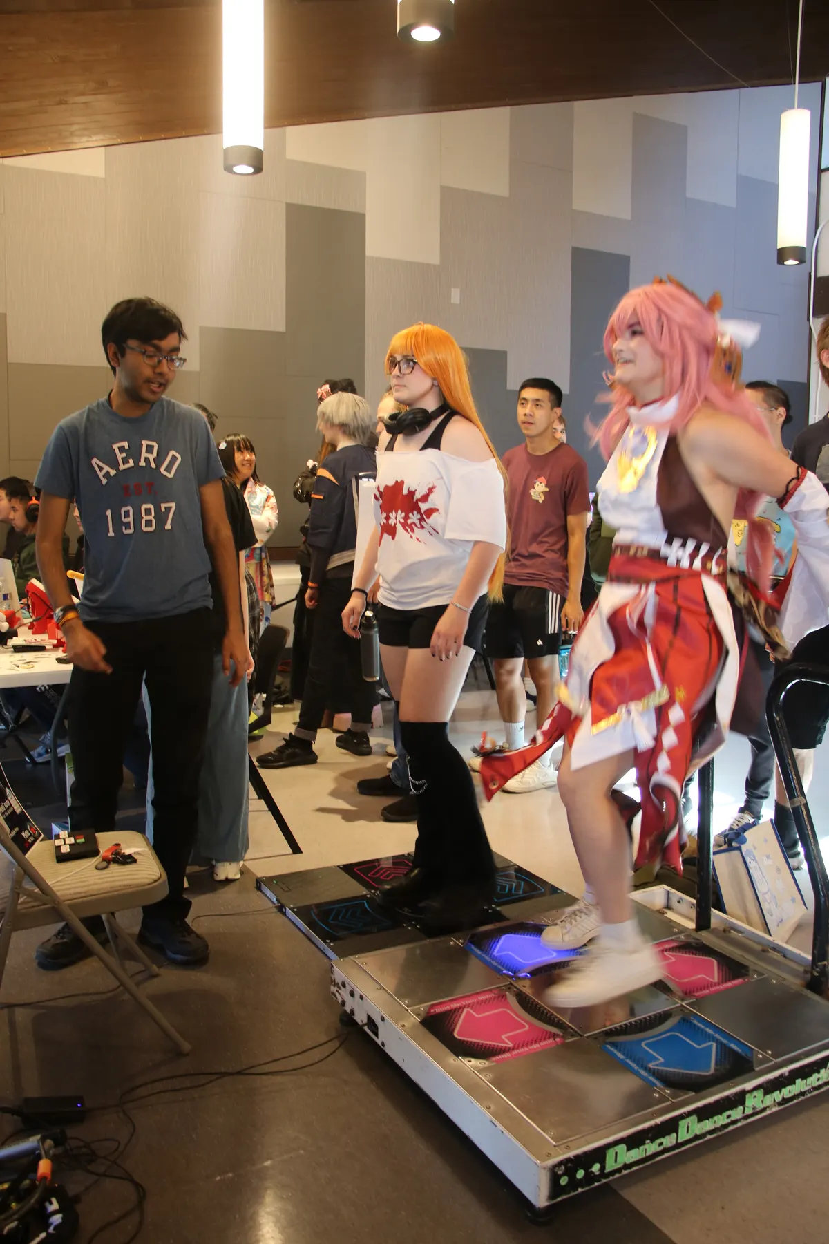 Cosplayers using the dance pad setup at SlugCon 2026