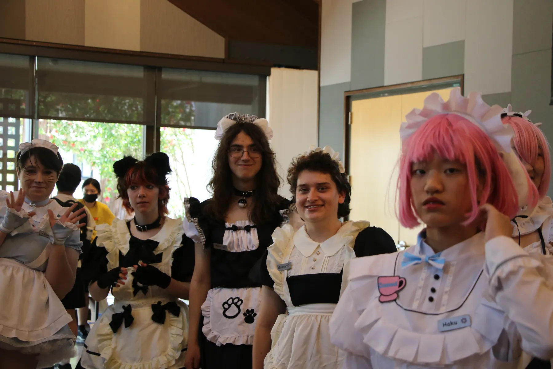 maid cafe participants posing together indoors