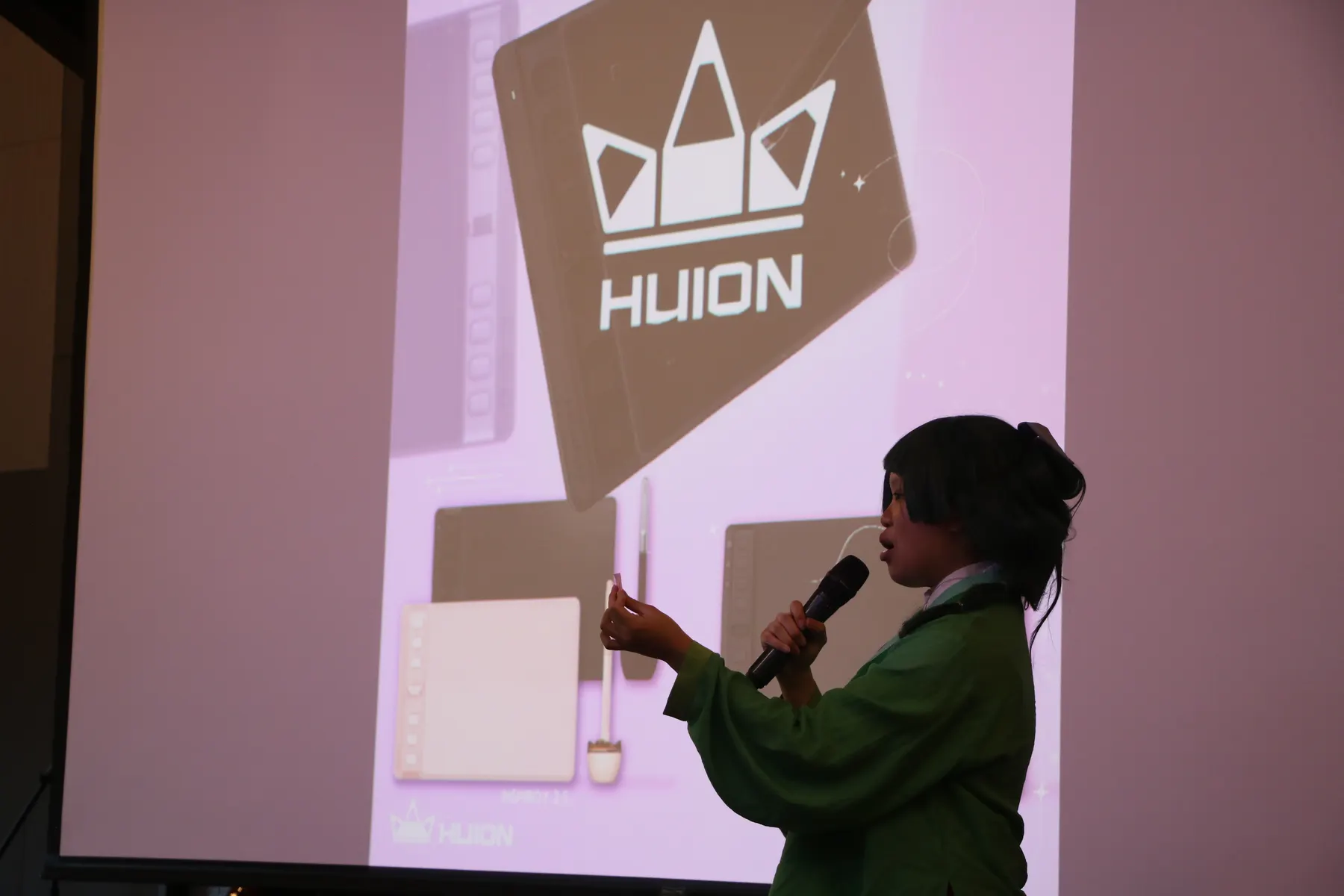 speaker presenting on stage during a SlugCon panel